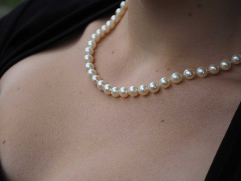 Pearl necklace around neck